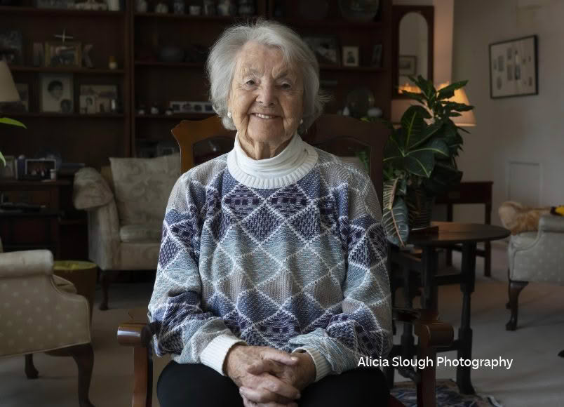 Dr. Audrey Evans sitting on chair inside