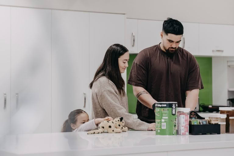 A family making breakfast in the Domain House kitchen