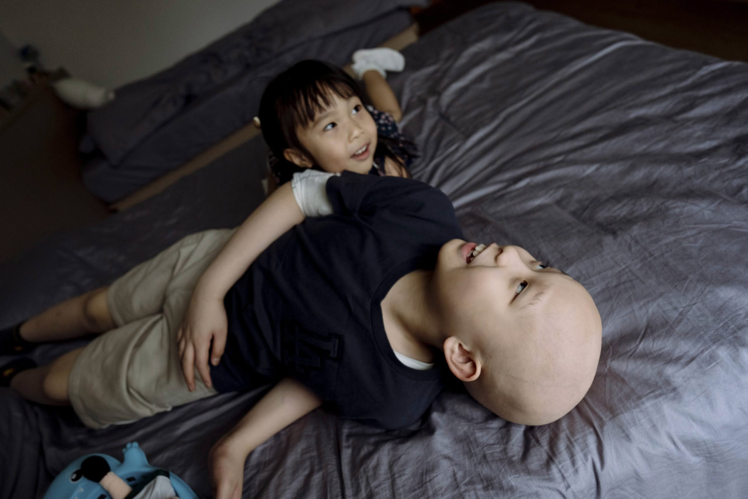 Siblings playing on bed