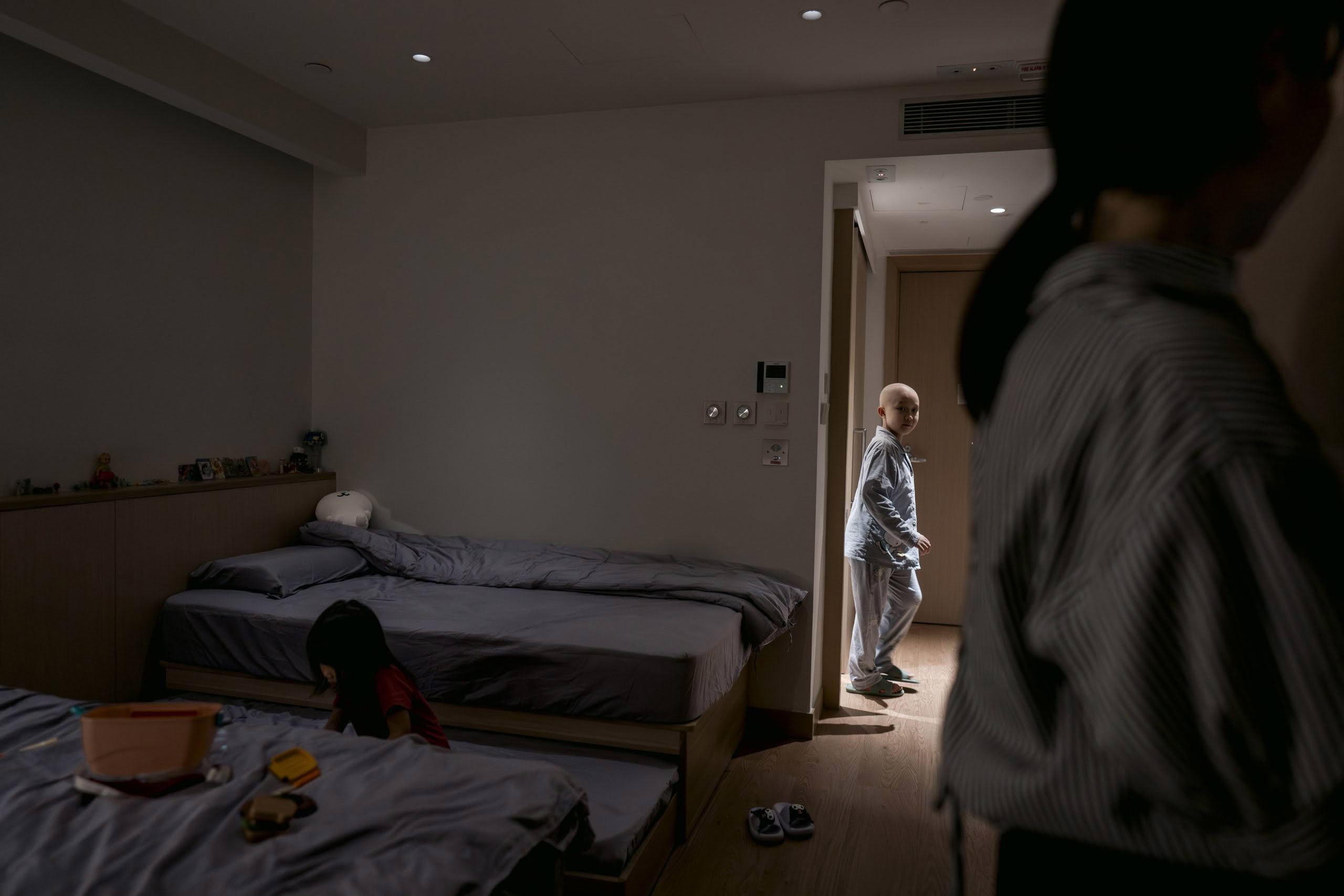 Children in pajamas and parent in room