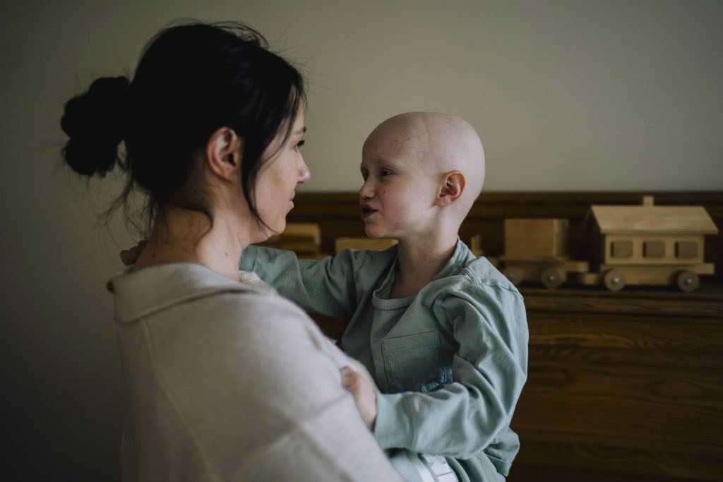 Woman embracing a young child in care