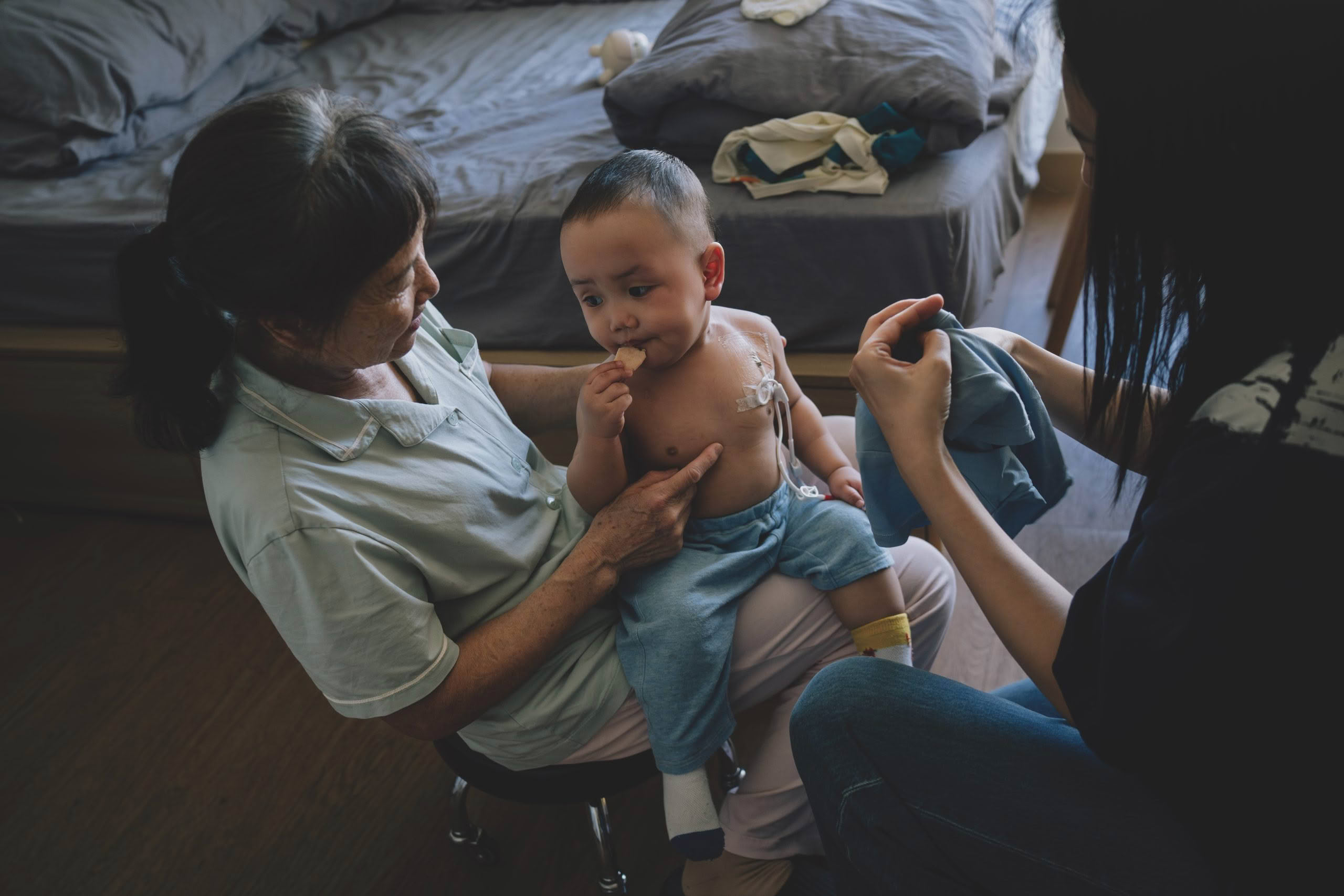 Mum and Grandma dressing child