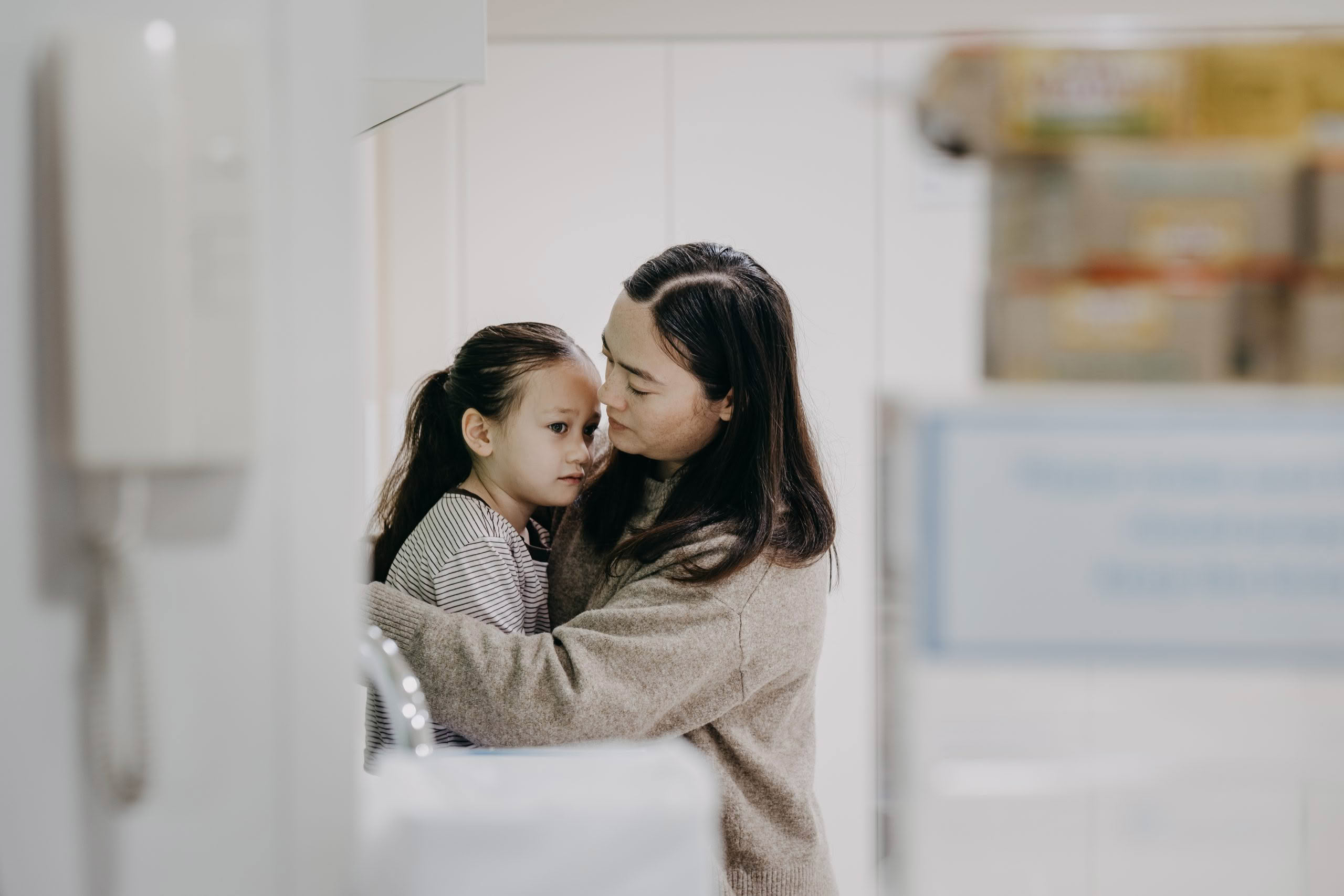 Mum consoling daughter